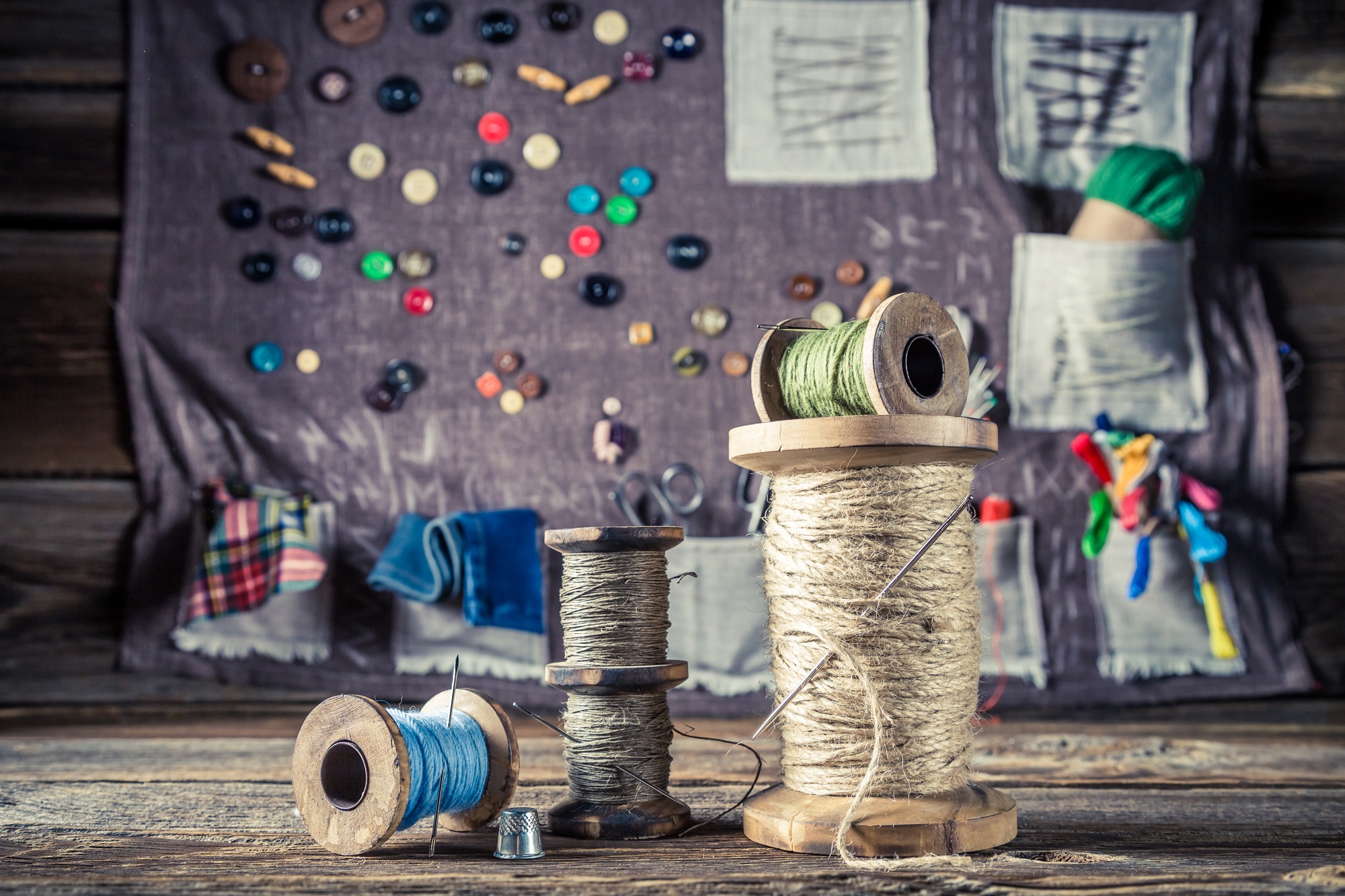 Old threads and needles in sewing workshop