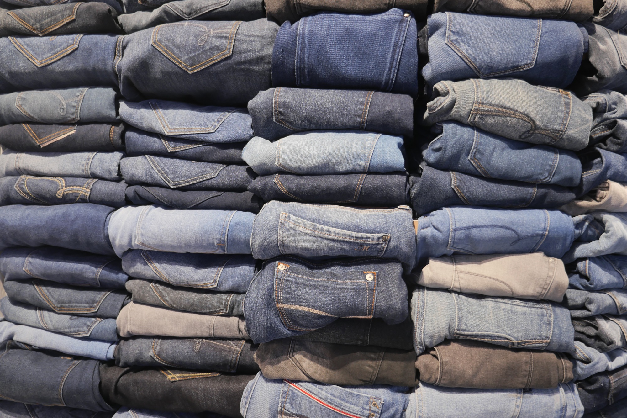 Stack of various blue jeans ,