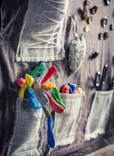 Handmade sewing mat with scissors, threads and needles in tailor workshop