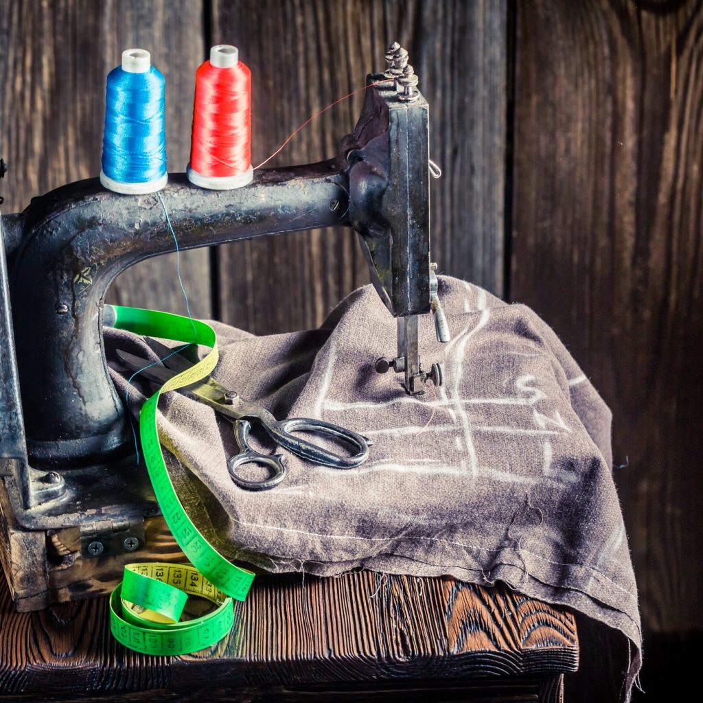 Old sewing machine with scissors and threads